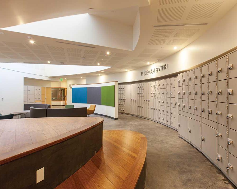 Instrument lockers flank the open student lounge in Hedy’s Hangout, which has easy access to the Caryn Borland ’85 Recording Suite., the bottom floor music lesson and practice room hallway, the music classroom, the music library, and the music office.