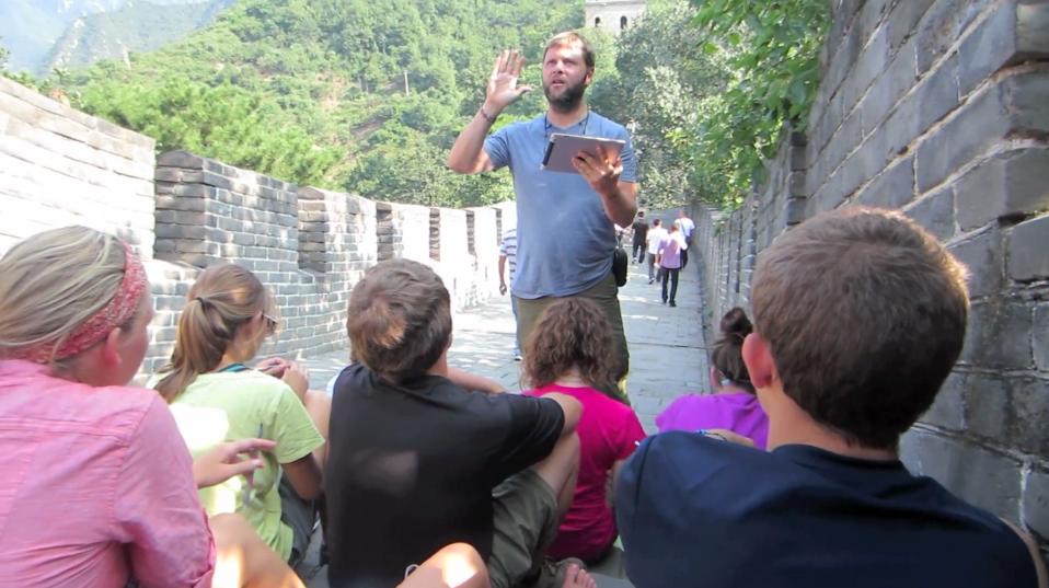 Man teaching to students on the Great Wall of China